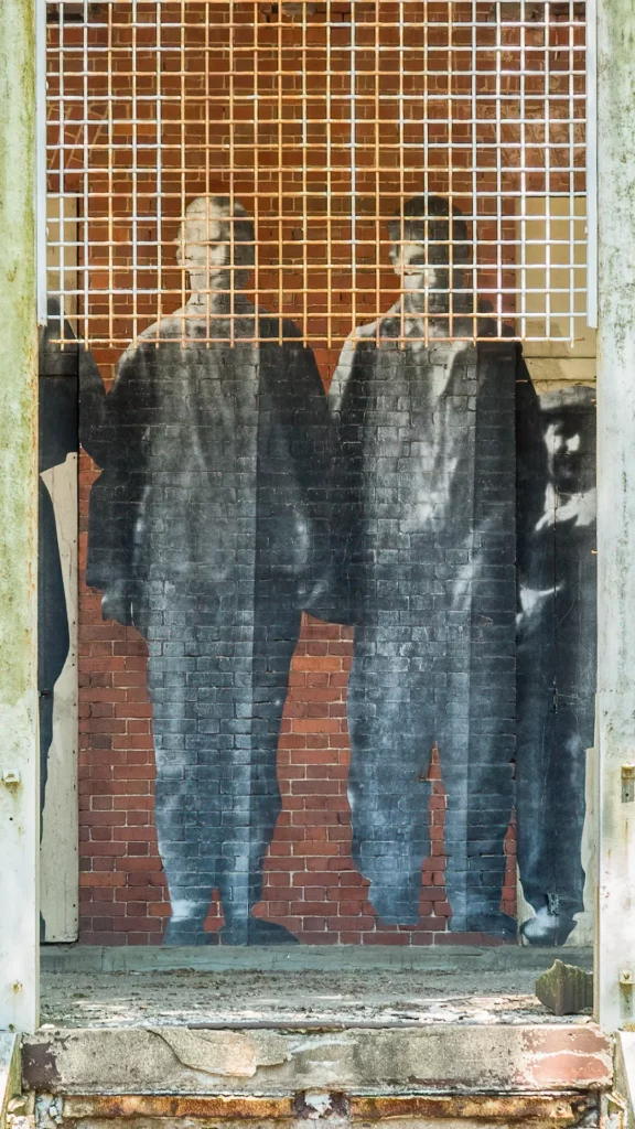 Which project by JR highlights the situation of migrants, using giant portraits?